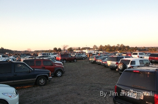  Packed parking lot at dawn on St. Mark's, FL heliport.  Whooping Crane flyover viewers crowded along river (left) and near Operation Migration trailers (top). Whooping Crane flyover, St. Mark's, Florida, January 17, 2009.