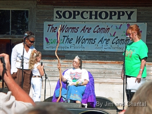  The new queen of the  Sopchoppy Worm Gruntin' Festival (sitting)  is welcomed by the "old" queen (little girl)